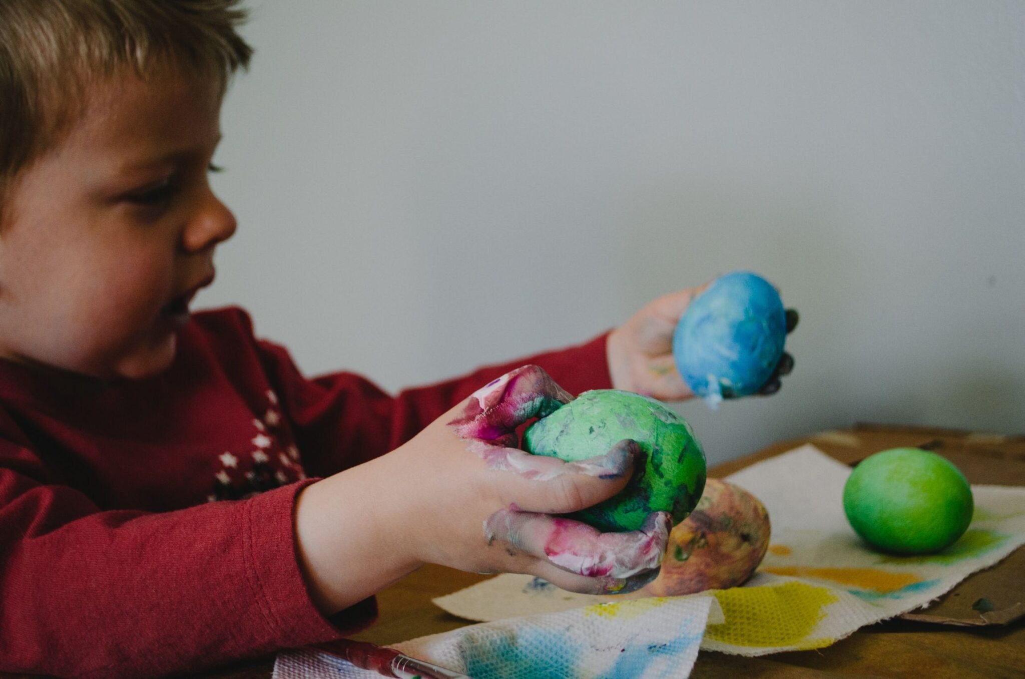 Child painting with colorful paint