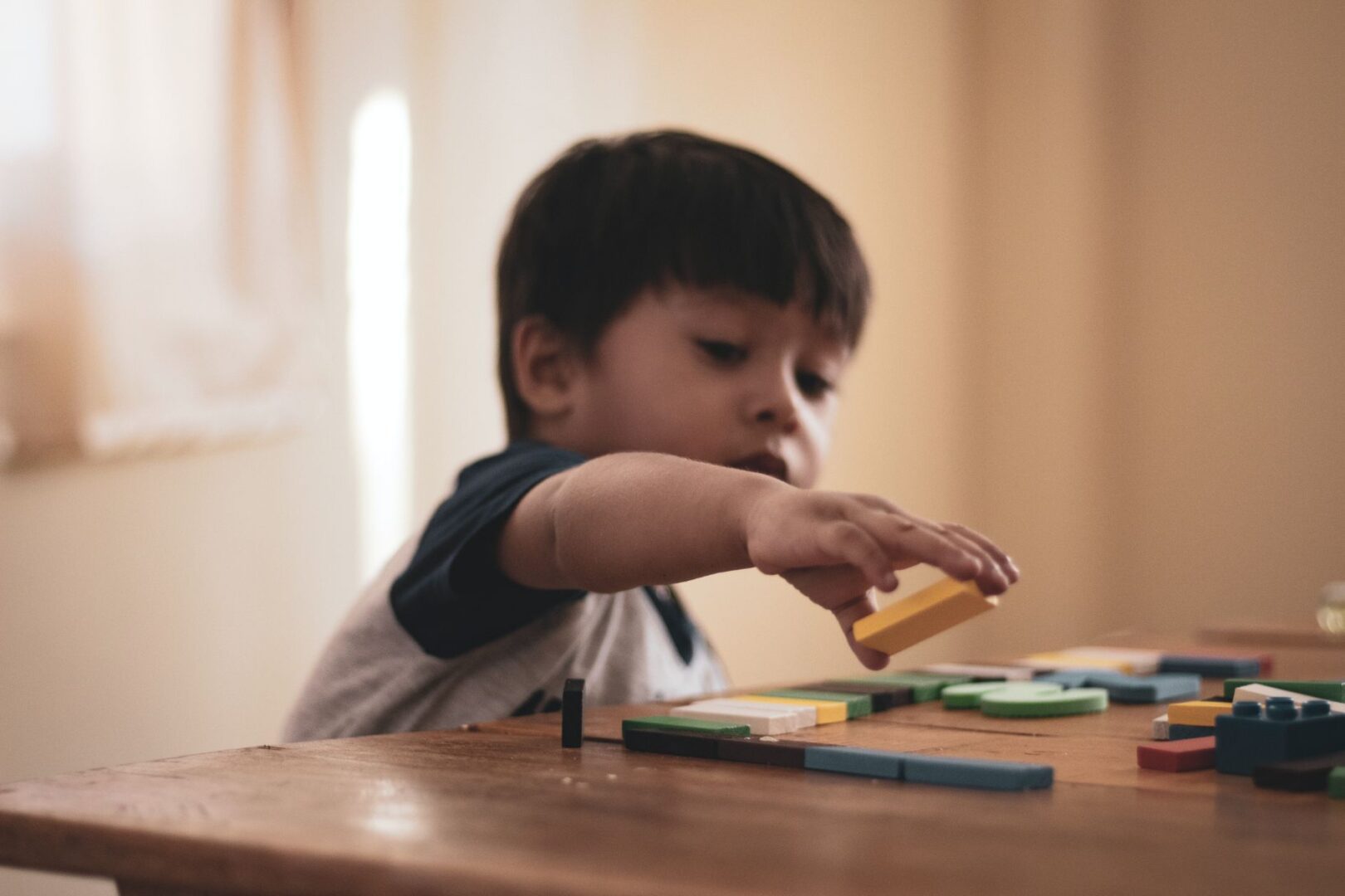 Child engaged in learning activity with blocks